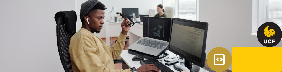 coding on  a computer with earbuds 