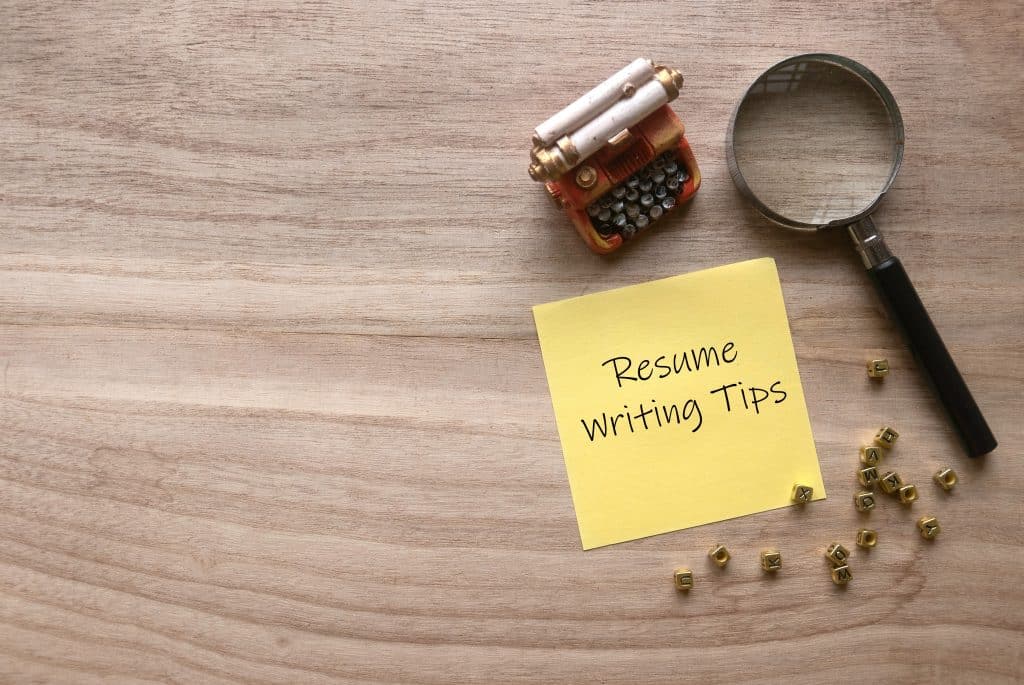 A yellow note with "Resume Writing Tips" written on it for professional development